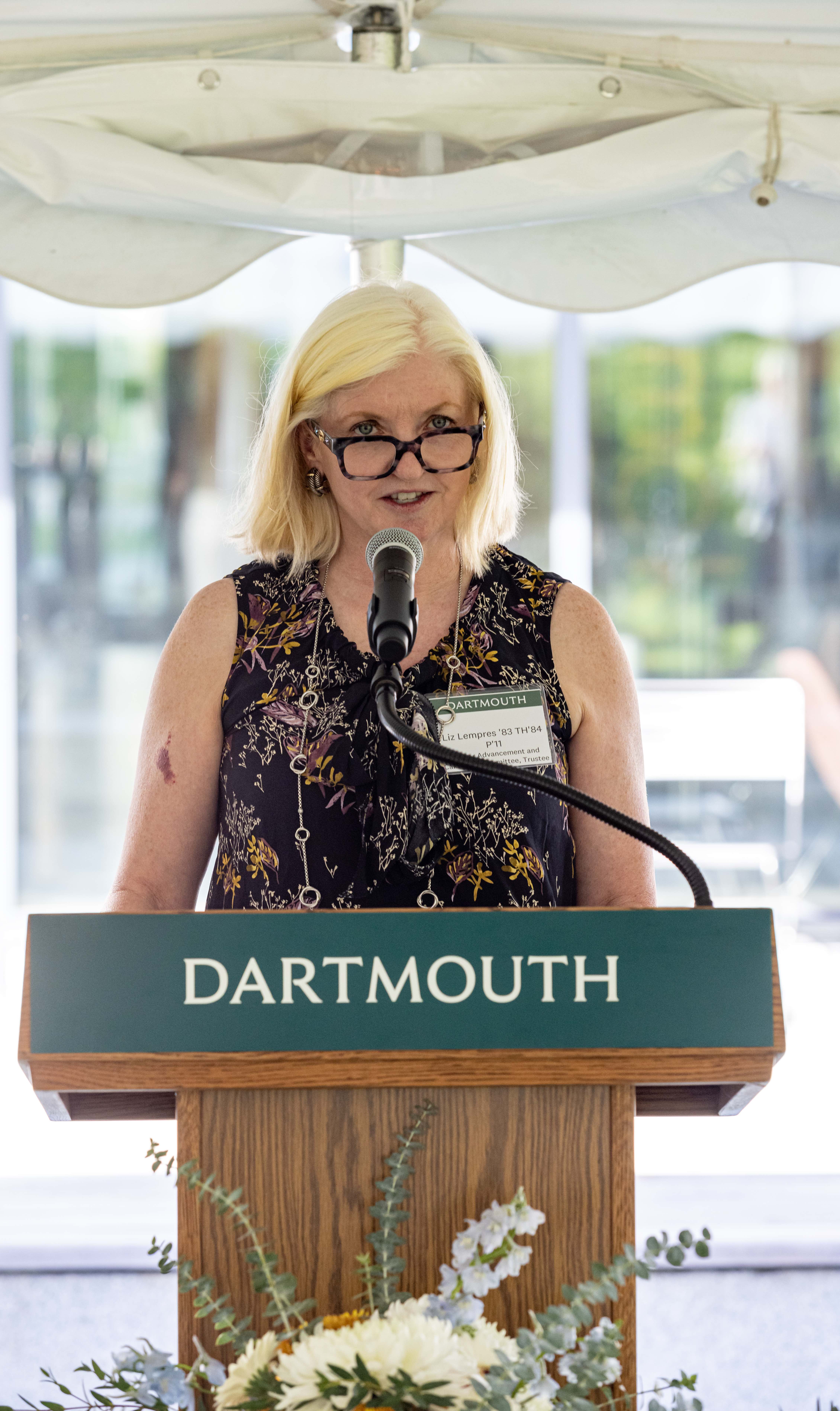 Elizabeth Cahill Lempres ’83 TH’84 is standing behind Dartmouth Podium