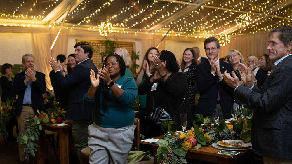 People applauding the 3 billion dollar milestone announcement