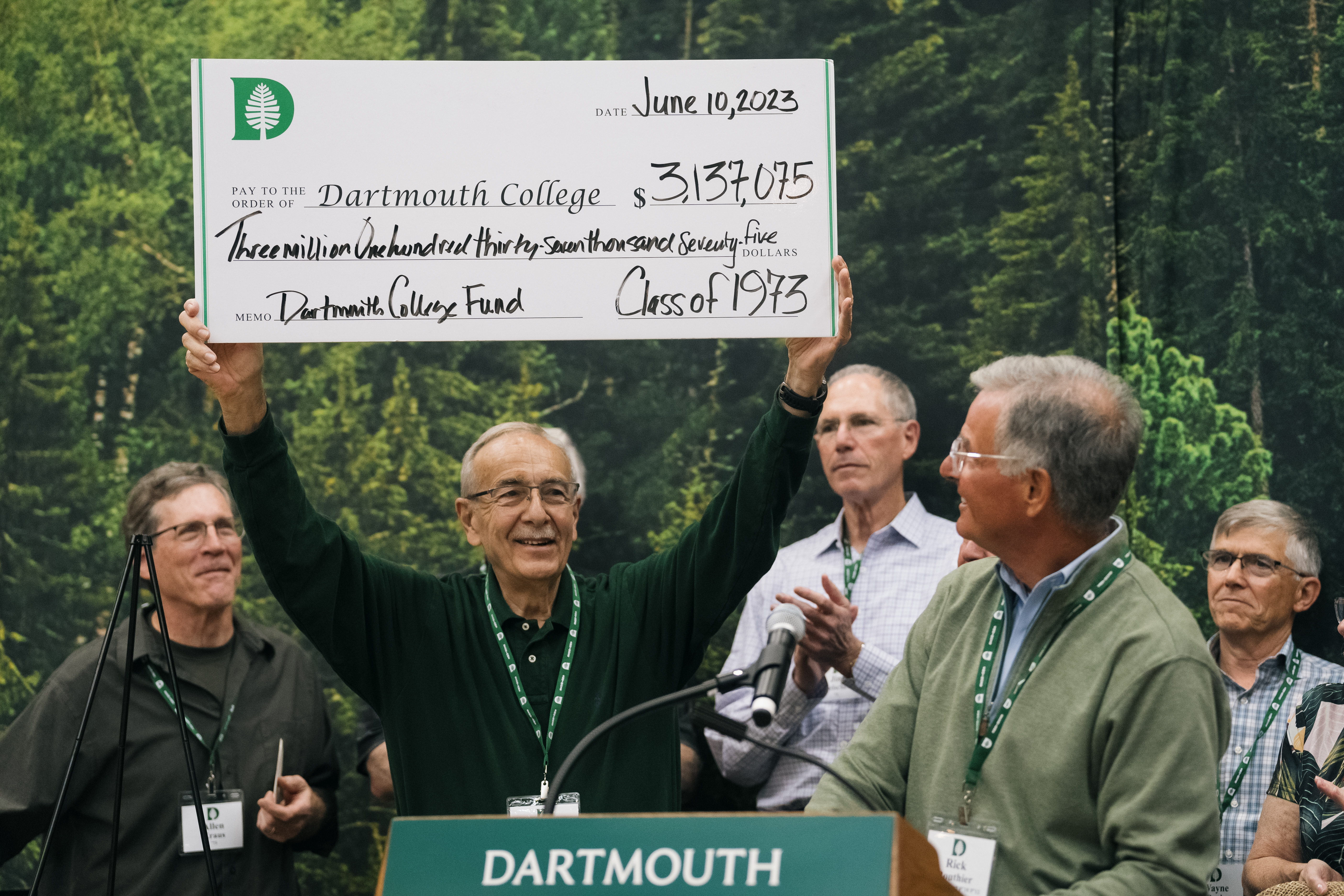 Member of ’73 holding up their giant check to the Dartmouth College Fund