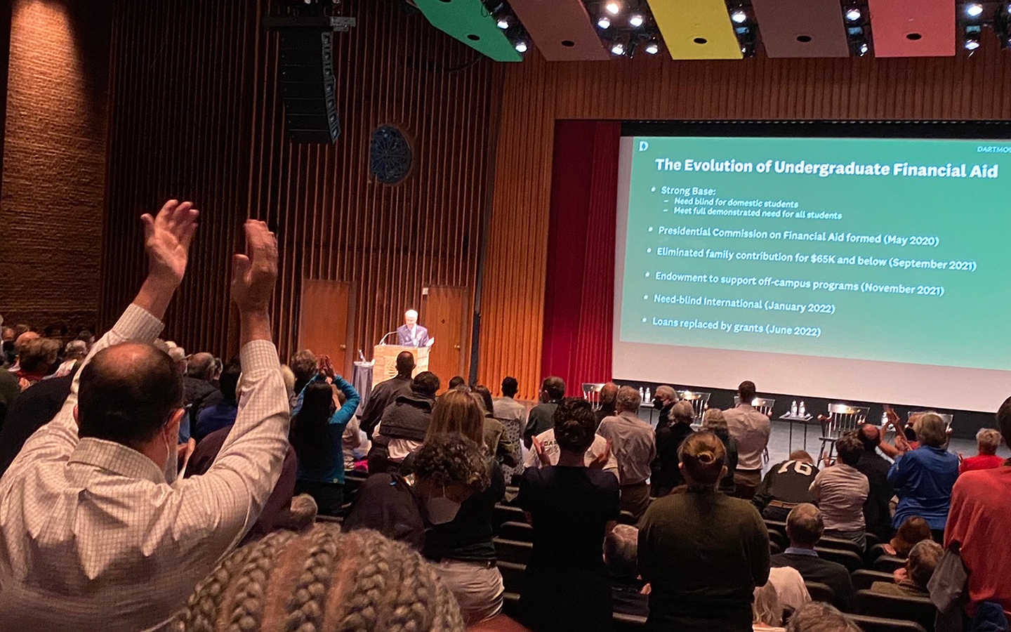 Standing ovation during reunion event announcing the elimination of student loans
