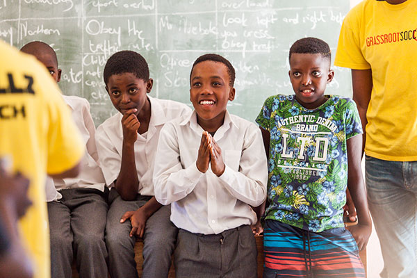 three boys in front of a chalkboard