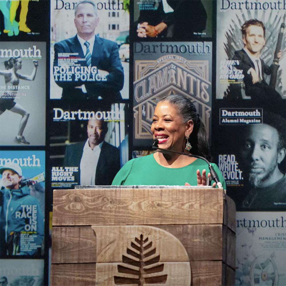 Laurel Richie at a podium in front of Dartmouth Alumni Magazine covers