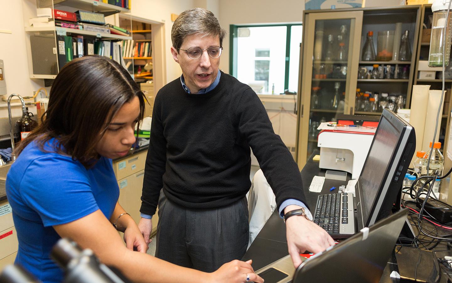 Immunology Program member and Professor of Microbiology and Immunology Charles Sentman in a teaching moment with Tiffany Coupet, Guarini ’20, in a photo taken pre-COVID-19 protocols.