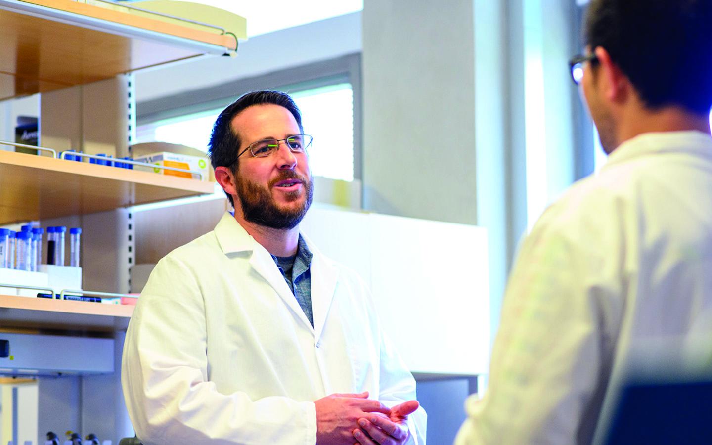 Jason McLelland in his white coat in a lab