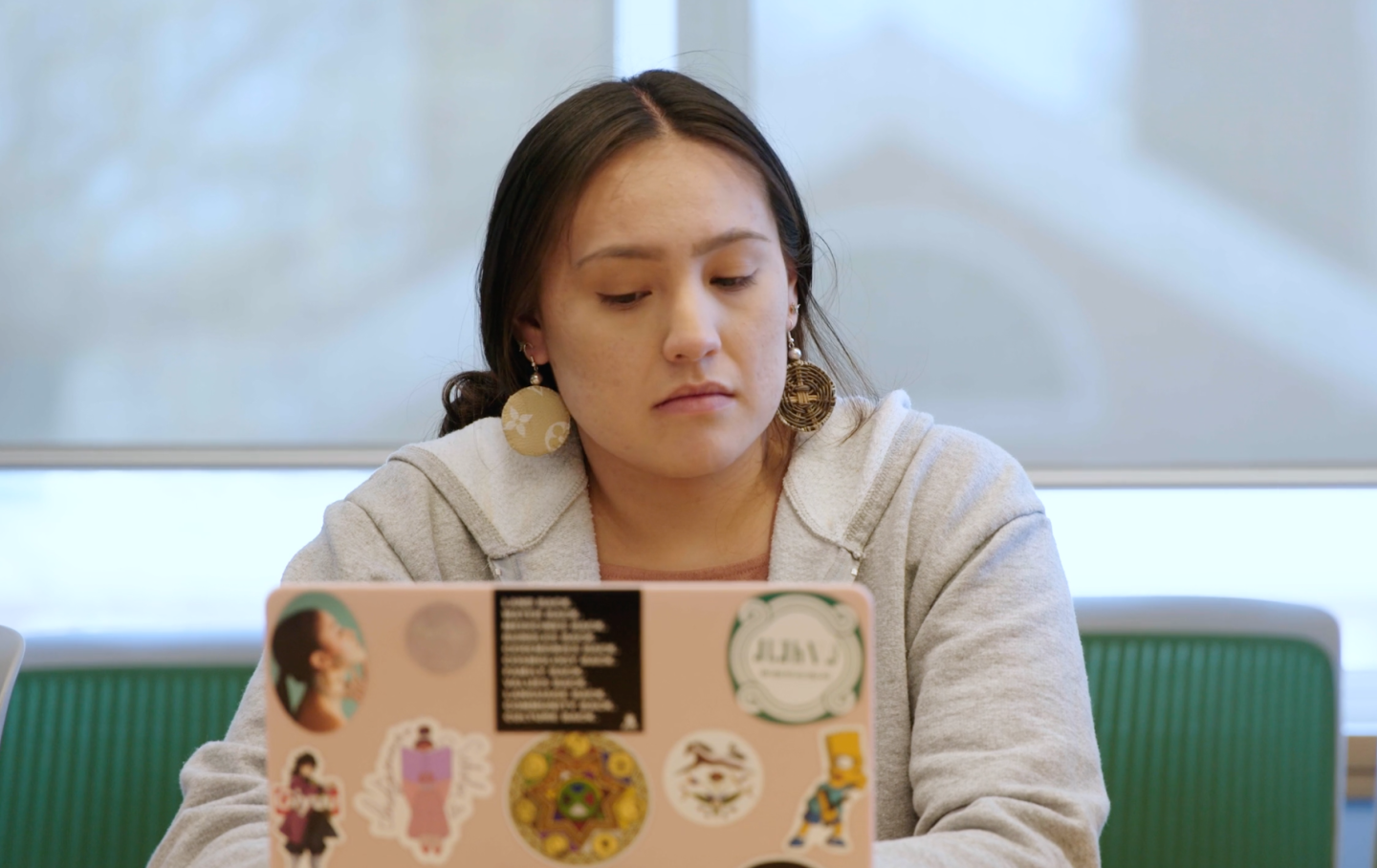 Student Raylen Bark looking at a laptop in a classroom