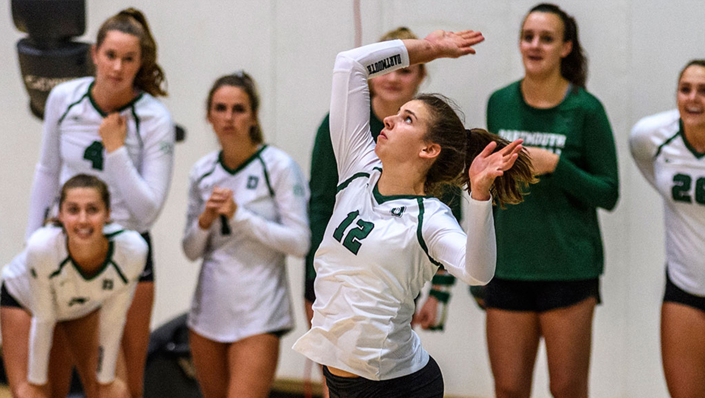 Grace Wiczek serves a volleyball