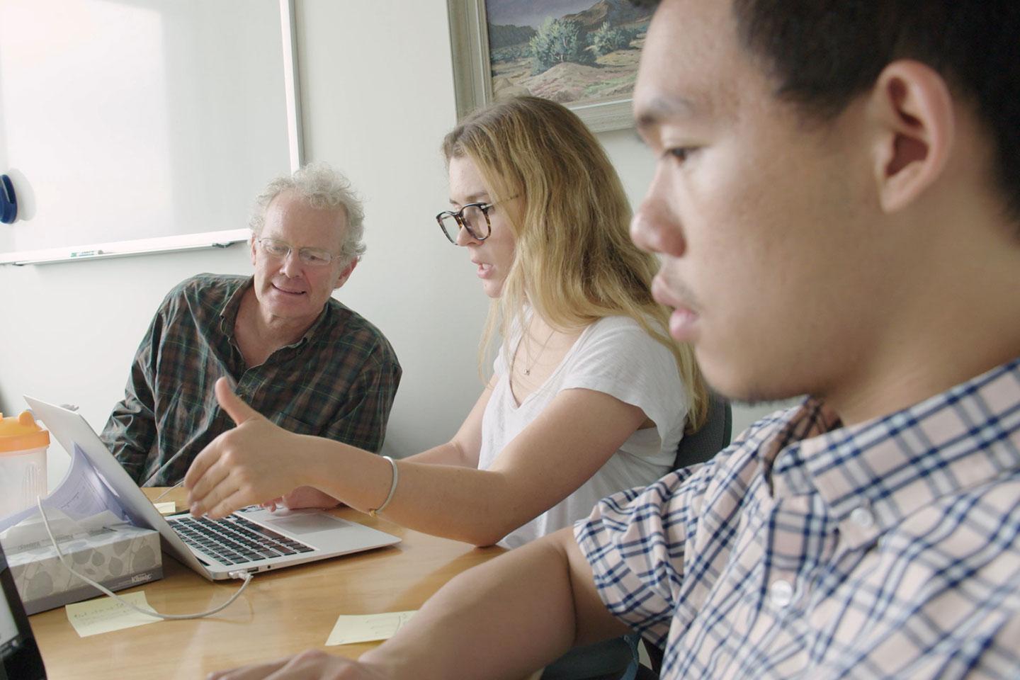 Dartmouth students Vincent Chang ’21 (right) and Hannah Utter ’21 (center) are working with Dr. Jim Sargent, director of the Koop Institute, to analyze fast-food commercials directed at young children.