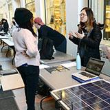Two students discuss solar panels
