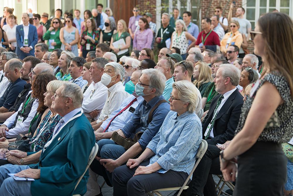 A seated crowd looks at the dedication event