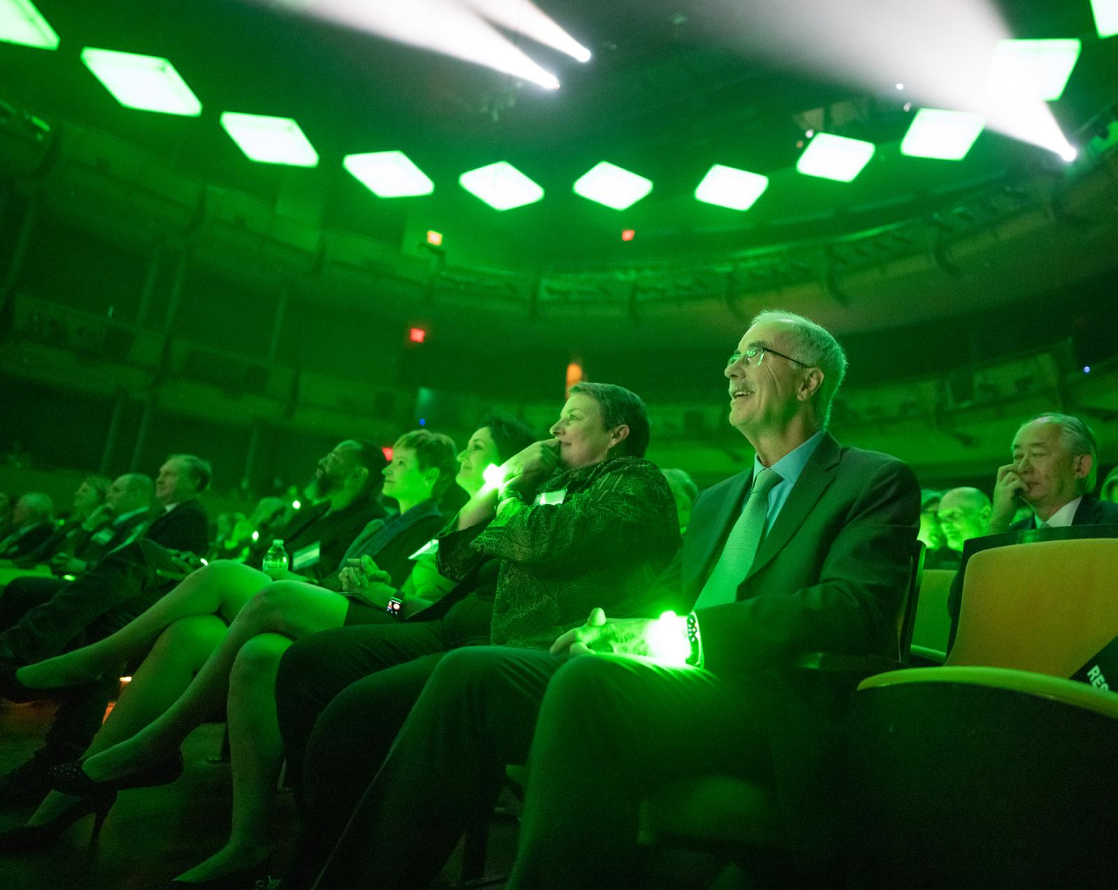 President Hanlon sitting with a glowing green wristband