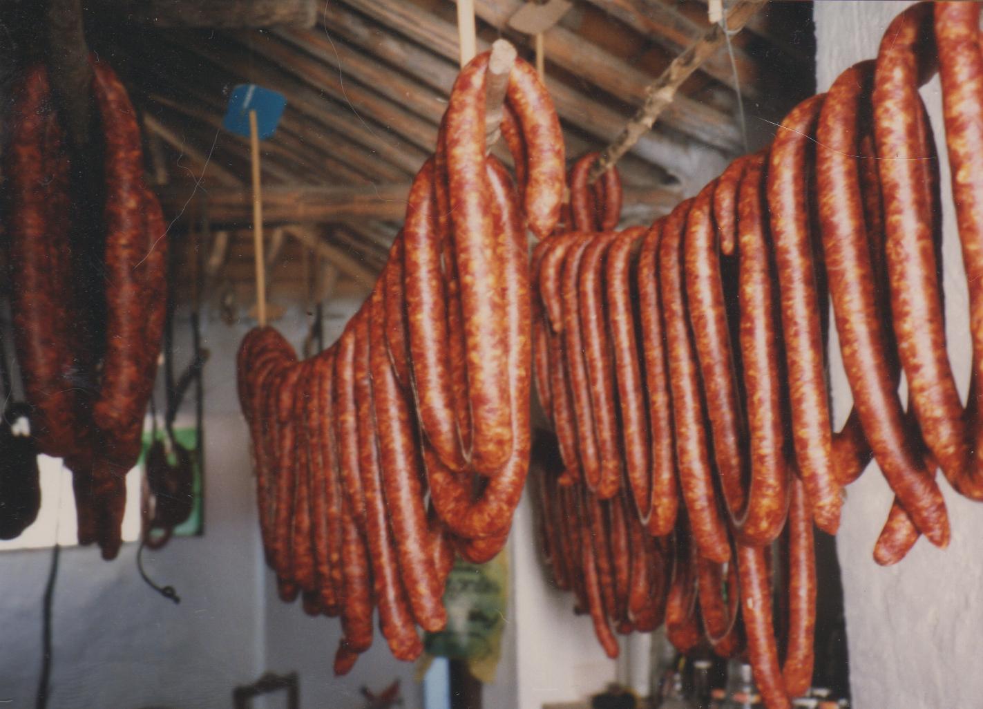 Sausages hanging from strings.