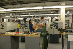 Dartmouth students assemble mechanical linkage prototype in the Thayer School of Engineering Machine Shop.