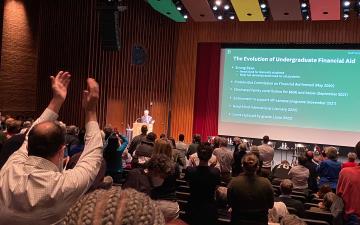 Reunions audience reacts to no loans announcement with standing ovation