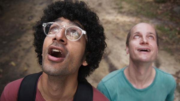 two men looking upward with expressions of amazement