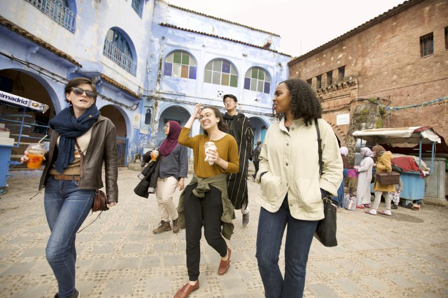 Students walk through a busy square in Morocco.